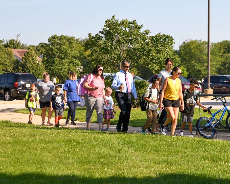 Students get dropped off at Fox Chase Elementary School in Oswego during the first day of the school year on Wednesday Aug. 16, 2023, in Oswego.