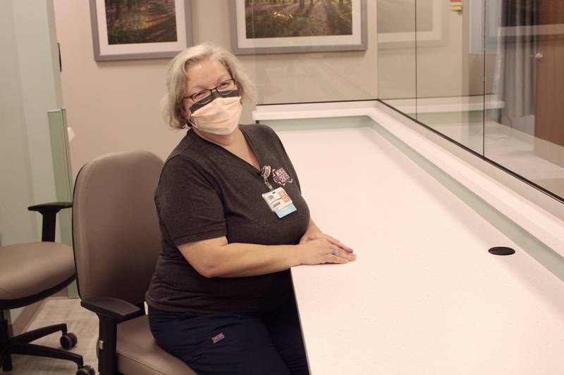 Jamie Sodaro, an oncology certified medical assistant, sits where her new station will be once the third-floor unit opens at CGH Medical Center's Main Clinic in Sterling. She says the area behind her will be filled with educational and informational displays for patients.