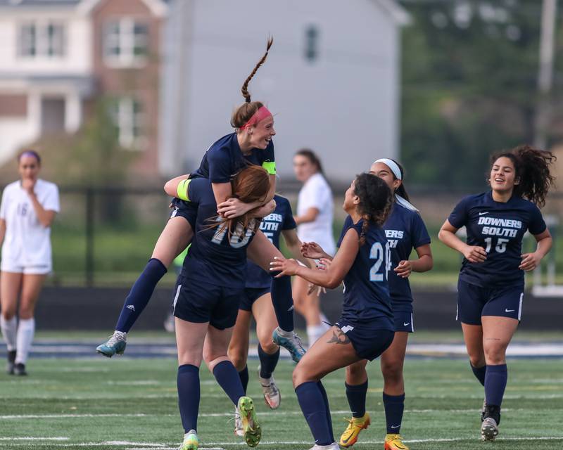 Downers Grove South's Emily Petring (13) celebrates with teammates after her game tying goal during Class 3A Addison Trail Regional final soccer match between Downers Grove South at Downers Grove North.  May 19, 2023.