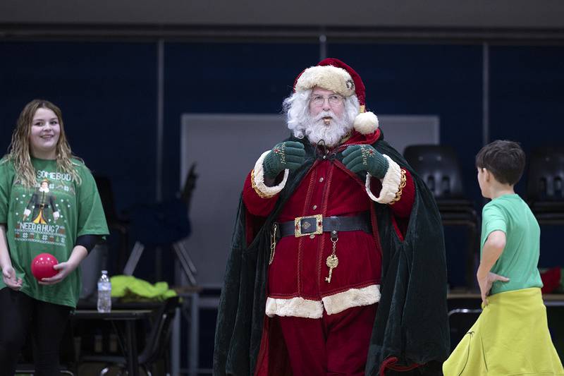 Santa plays the part of referee, often times keeping the Grinch and his bag of tricks in check on Saturday, Nov. 23, 2024, in Rock Falls.