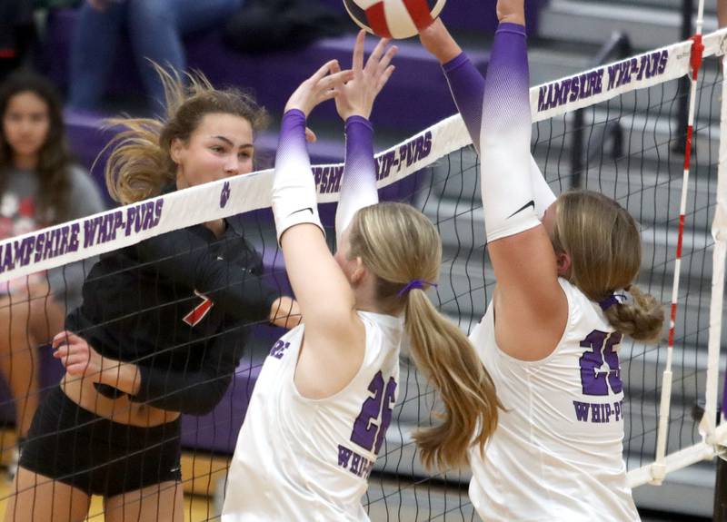 Huntley’s Mia Jacobelli hammers the ball past Hampshire’s Anna Schiltz, center, and Hailey Homola in varsity girls volleyball at Hampshire High School in Hampshire on Tuesday, Sept. 23, 2025.