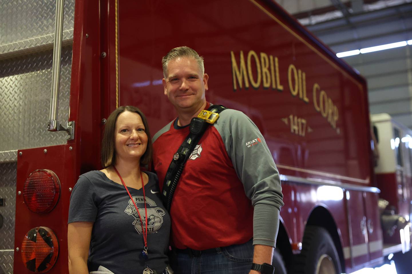 Brianne “Bri” Smith, a reliability supervisor at ExxonMobil Joliet Refinery, and her husband Michael Smith, a fire chief at the plant, stand near a fire truck at the plant’s firehouse on Thursday, Sept. 8, 2022.