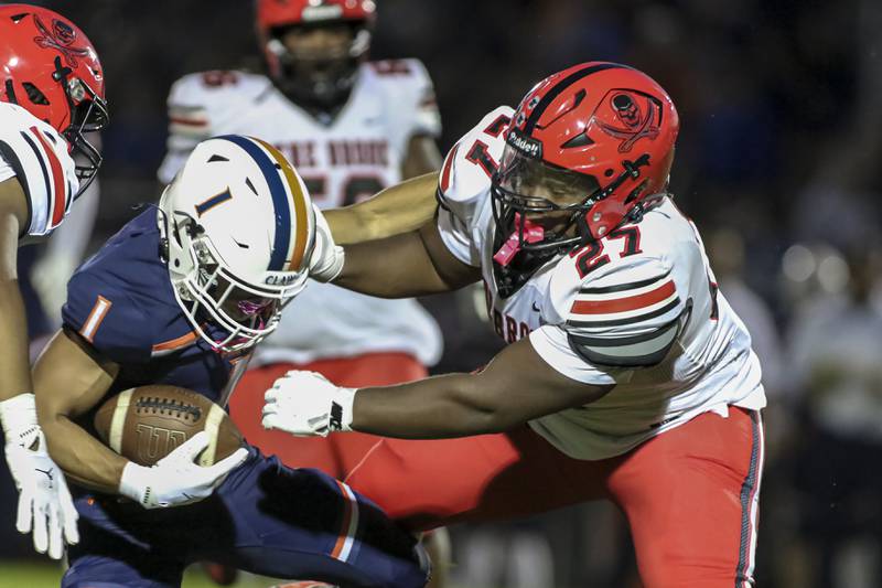 Bolingbrook's Peyton Williams (Brooks) (27) tackles Oswego's Teddy Manikas (1) during football game between Bolingbrook at Oswego Friday, Sept 12, 2025  in Oswego.
