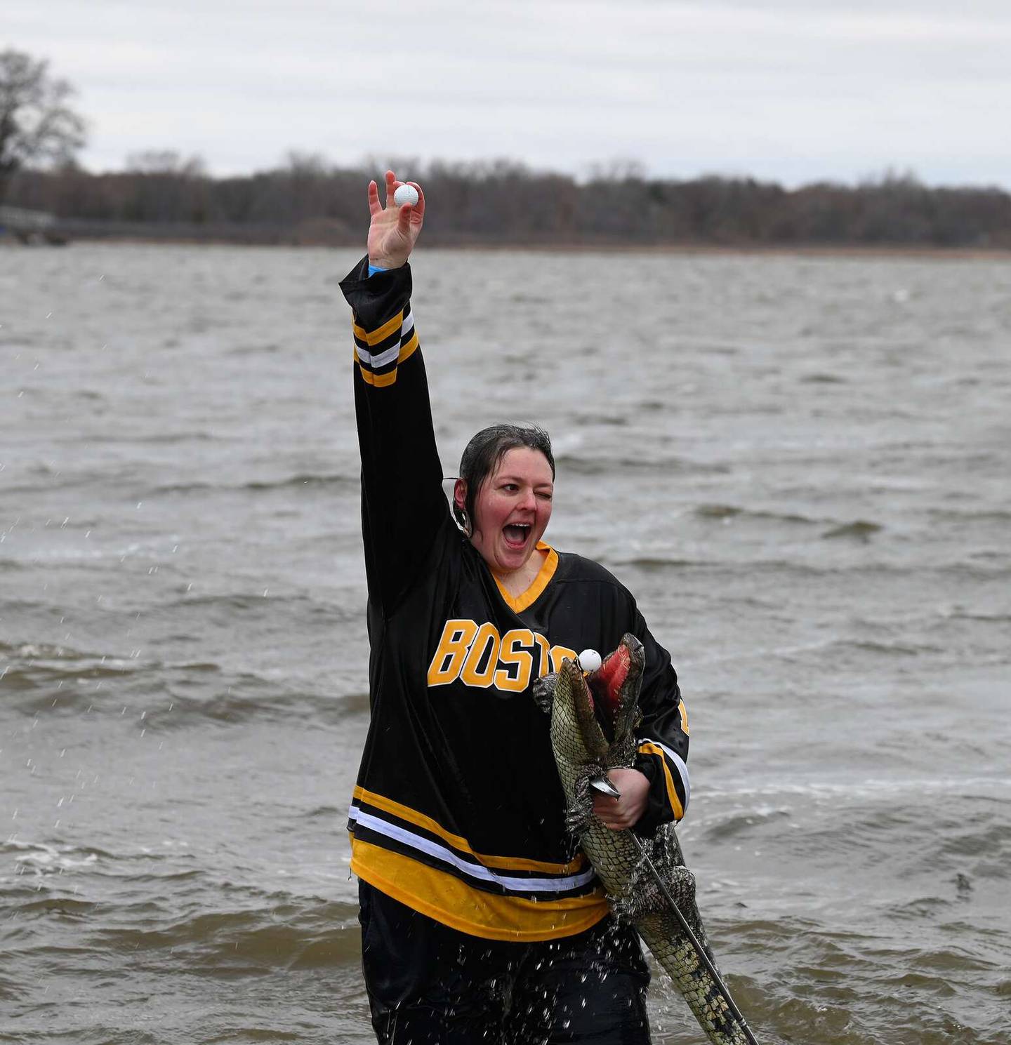 Ashley Pollard, a Special Olympics coach from Spring Grove, raises her arm in triumph Sunday after taking a dip during the Fox Lake Polar Plunge.