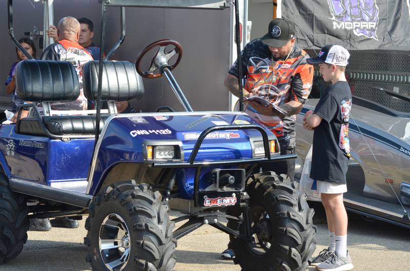 Trevor Vicary, 11, of North Pekin gets an autograph by racer Ricky Rush of Chicago, who said it was his third year racing at the World Series in Cordova.