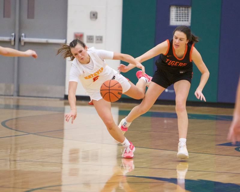 Batavia's Brooke Carlson is fouled by Wheaton Warrenville South's Ashlyn Adams at the Class 4A Regional Final on Friday, Feb.26,2024 in Bartlett.