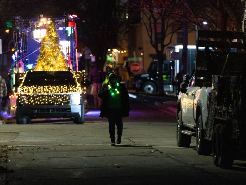 Brenda Rathman of South Elgin walks back to the  St. Charles Women’s Club float before the Holiday Homecoming Electric Christmas Parade in St. Charles on Saturday, Nov. 30, 2024.