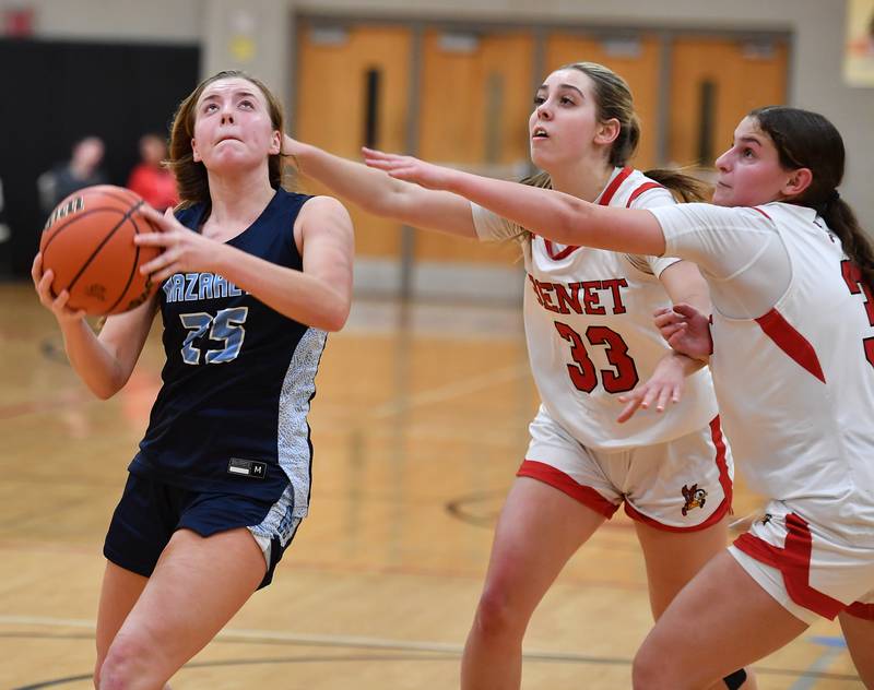 Nazareth's Amalia Dray (left) goes to the basket while being double teamed by Benet's Magdalena Sularski (33) and Aria Mazza during a game on Dec. 13, 2023 at Benet Academy in Lisle.