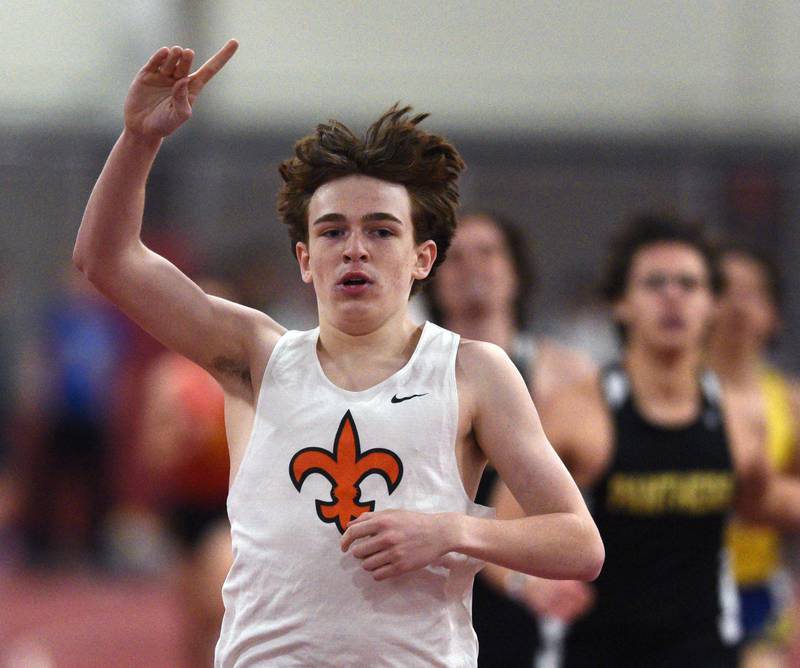 St. Charles East’s Michael Wilson celebrates as he wins the 800-meter run during the DuKane Conference indoor track meet at Batavia High School on Friday, March 21, 2025.