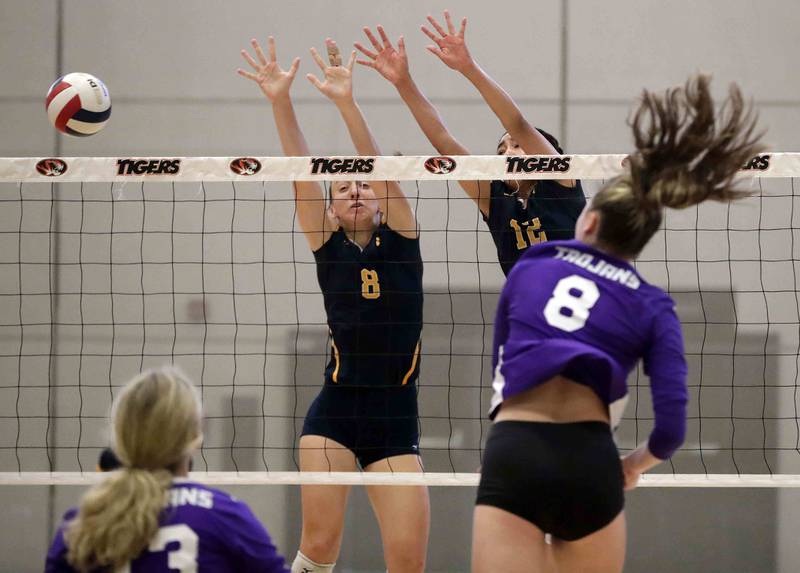 Brian Hill/bhill@dailyherald.com
Downers Grove North’s Colleen Engstler (8) spikes the ball past Neuqua Valley’s Yuliia Schscepkina (8) and Bryanna Jones (12) Saturday September 17, 2022 in Warrenville.