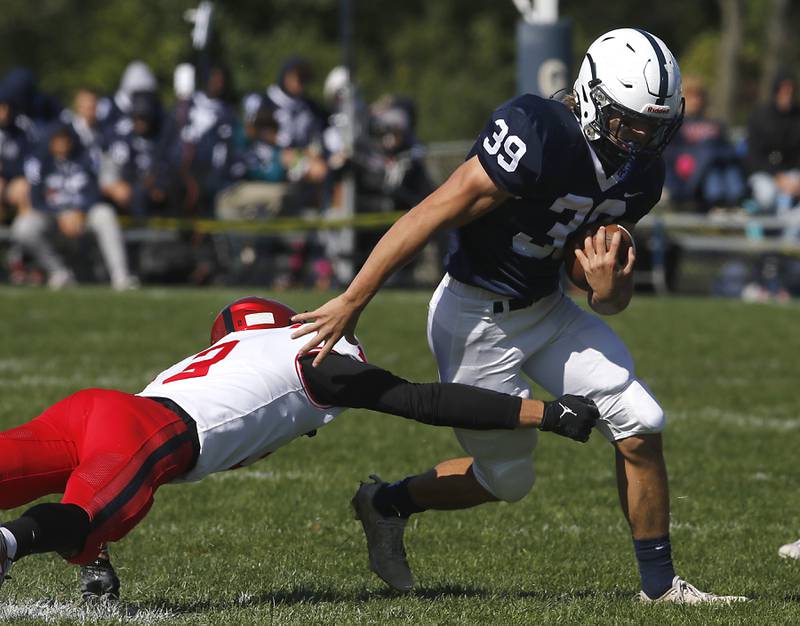 Huntley's Zack Garifo tries to tackle Cary-Grove's Holden Boone during a Fox Valley Conference football game on Saturday, Oct. 7, 2023, at Cary-Grove High School.