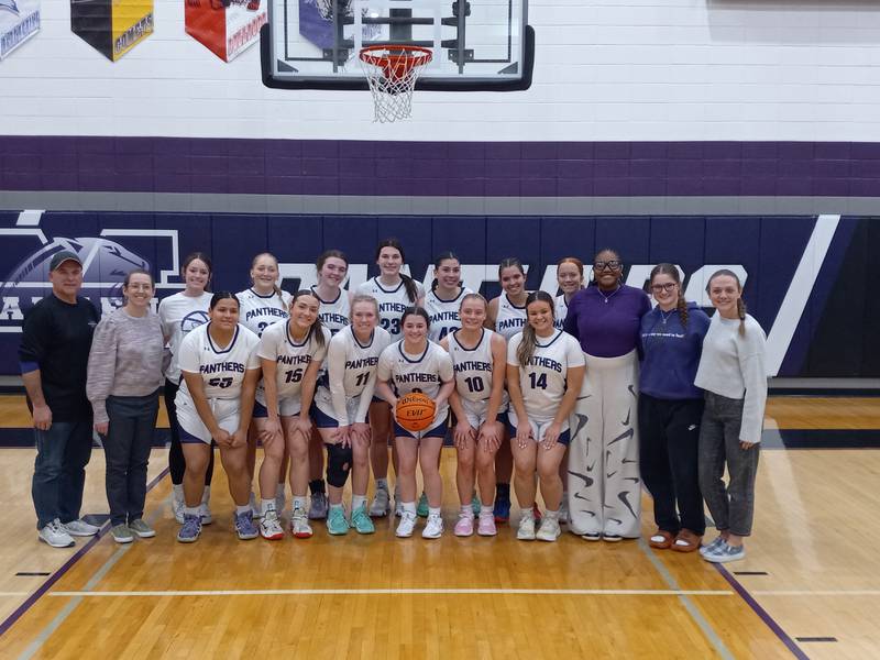 The Manteno girls basketball team poses for a celebratory photo after beating Coal City 53-40 on Feb. 10 to clinch the Illinois Central Eight Conference title, the first for the program since 1990.