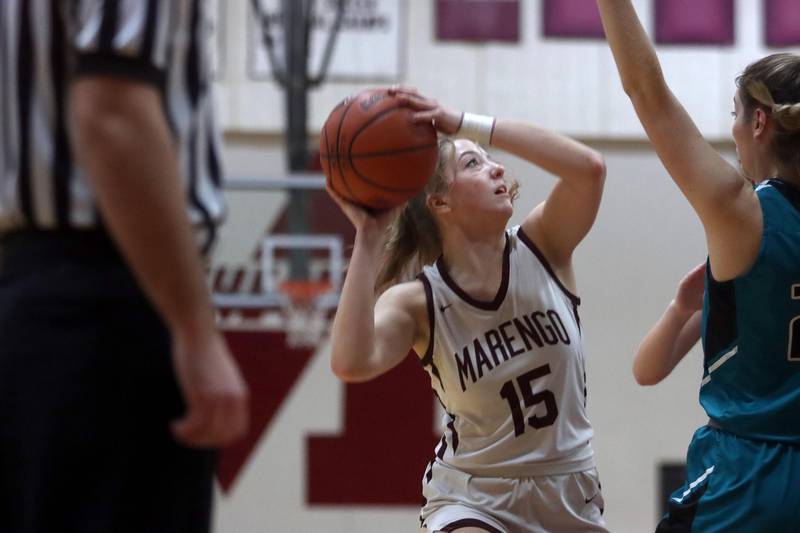 Marengo’s Gianna Almeida works under the hoop against Woodstock North in girls basketball at Marengo on Thursday.