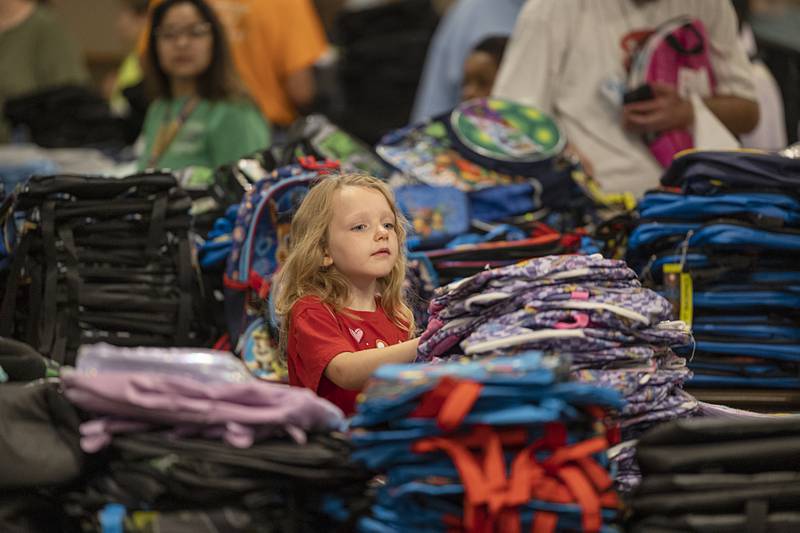 Jenelle Allen, 6, peruses the backpacks for the perfect one Thursday, Aug. 8, 2024 at the Tools for Schools distribution in Dixon.