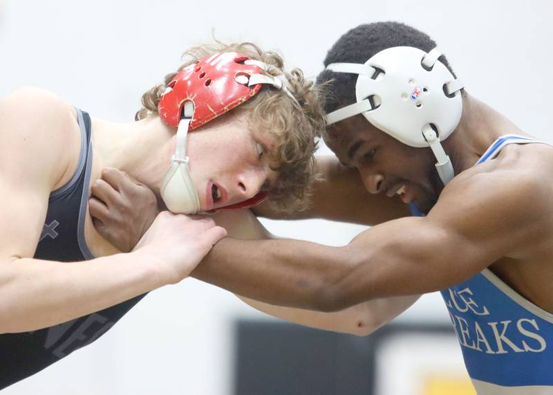 Woodstock’s Taqiuldin Baker, right, battles Marian’s Cam Spiniolas at 126 pounds in boys wrestling IHSA Class 2A Regional championship bout action on Saturday, Jan. 31, 2026, at Harvard High School in Harvard.