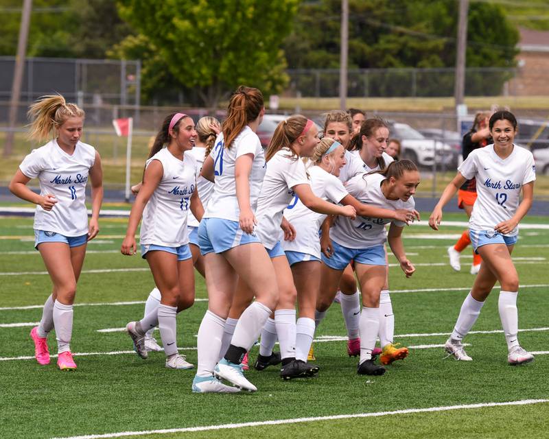 St. Charles North Laney Stark (19) gets congratulated by teammates to tie the game at 1 a piece with 6.9 seconds left in the game while taking on St. Charles East during the sectional title game on May 27th held at West Chicago Community High School.