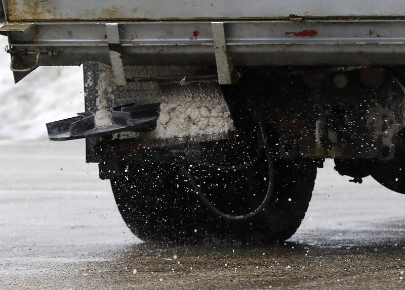 Salt is spread on the parking lot of the Walmart in Woodstock on Wednesday, Feb. 22, 2023, as a winter storm that produced rain, sleet, freezing rain, and ice moved through McHenry County.
