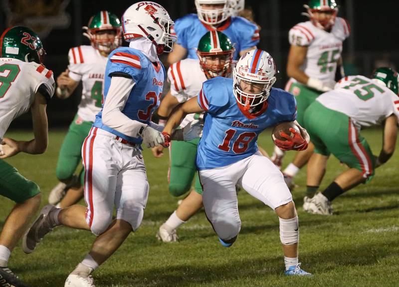 Ottawa's Jack Pongracz carries the ball against L-P as teammate Cody Green runs besides him on Friday, Oct. 4, 2024 at King Field.