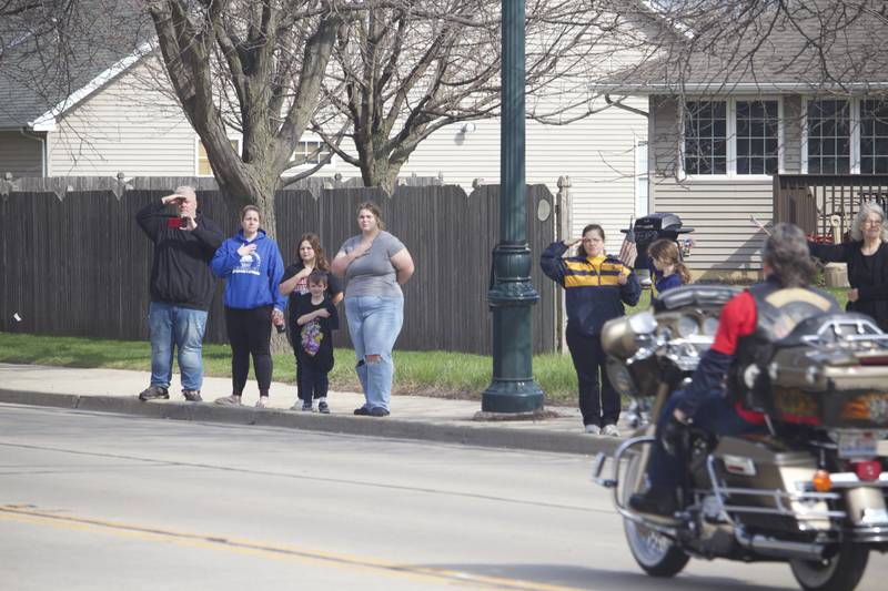 Attendees saluting during the funeral procession on Friday, April 18, 2025, outside Tezak Funeral Home in Joliet, for for U.S. Army Staff Sgt. Jose Dueñez Jr. He was one of four soldiers who died March 31, 2025 when their armored vehicle sunk in a bog during a training mission in Lithuania.
