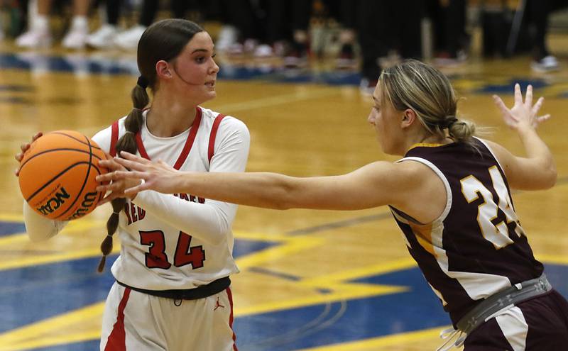 Huntley's Ava Mcfadden looks to pass as she is defended by Loyola Academy's Grace Bronski during the IHSA Class 4A Gurnee Warren Supersectional girls basketball game on Monday, March 3, 2025, at Warren Township High School in Gurnee.