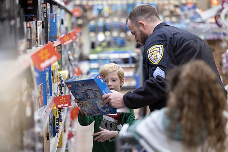 Owen Wilhite, 7, shows Dixon officer Ryan Bivins a Lego set Saturday, Dec. 9, 2023 at Dixon Walmart.