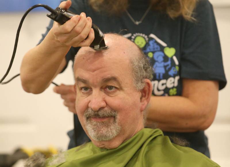 Mark Bierbom, Utica EMS director, has his head shaved during the 18th annual Illinois Valley Emergency Services St. Baldrick's event on Sunday, March 23, 2025 at Senicas Oak Ridge in La Salle.