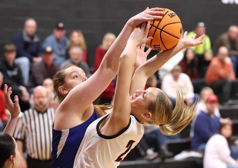 Hinckley-Big Rock's Sami Carlino (left) and Indian Creek's Gretta Oziah fight for a rebound during their game Monday, Jan. 13, 2025, at Indian Creek High School in Shabbona.