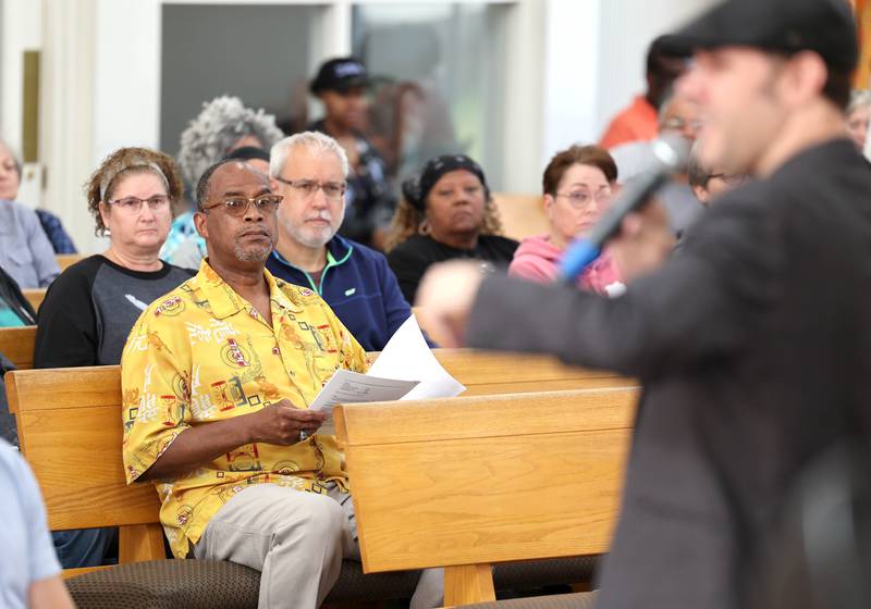 Attendees listen as Clint-Michael Reneau, vice president for student affairs at Northern Illinois University, talks about the proposed NIU Center for Greek Life during the informational meeting Thursday, May 18, 2023, at New Hope Missionary Baptist Church in DeKalb. The meeting centered on the the proposed plans for the vacant lot on the corner of Blackhawk Road and Hillcrest Drive in DeKalb.