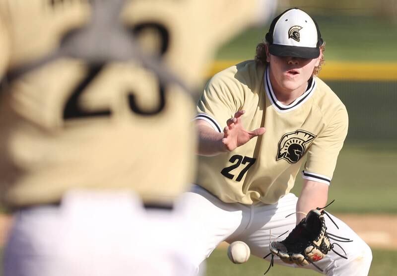 Sycamore's Jimmy Amptmann fields a bunt during their game against Kaneland Thursday, May 4, 2023, at Kaneland High School.