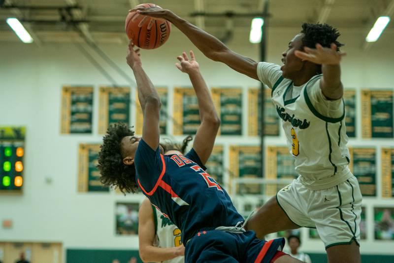 Waubonsie Valley's Tre Blissett (3) defends the paint against Oswego’s Dasean Patton (23) during a Waubonsie Valley 4A regional semifinal basketball game at Waubonsie Valley High School in St.Charles on Wednesday, Feb 22, 2023.