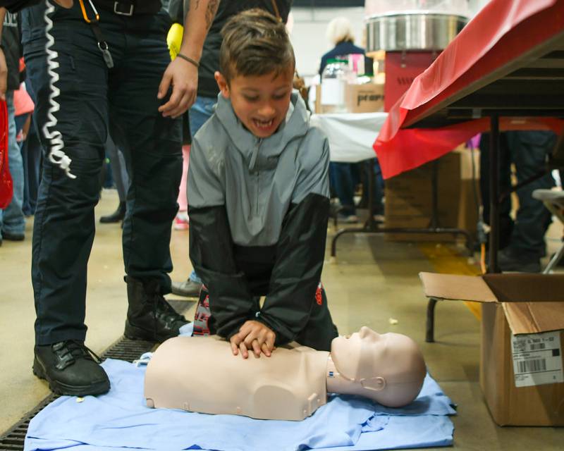 Tyler Smolinski, 8 years old, of Westmont learns how to do CPR during the Westmont fire department 100 year anniversary celebration held on Saturday Oct. 14, 2023.