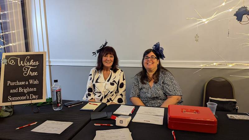 Shorewood HUGS members Carin Wilson, of Channahon and Stacy Larisey of Joliet oversee the wishes table at the Shorewood HUGS annual chocolate ball on Saturday, February 1, 2025, in Joliet.