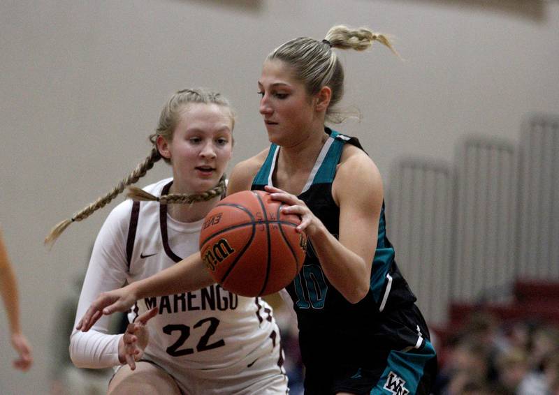 Marengo’s Dayna Carr, left, guards Woodstock North’s Addison Rishling in varsity girls basketball at Marengo Tuesday evening.