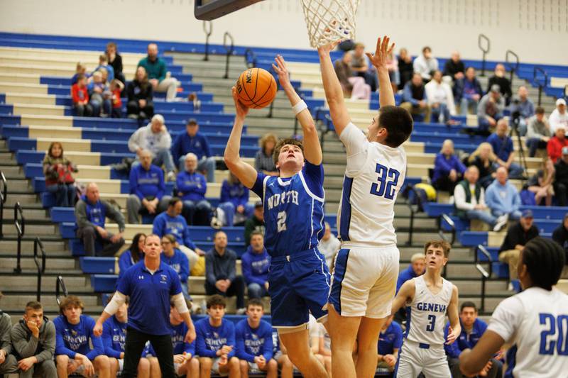 Wheaton North's Briggs Barnick hangs a shoot against Geneva's Ben Peterson on Friday, Feb.13,2026 in Geneva.