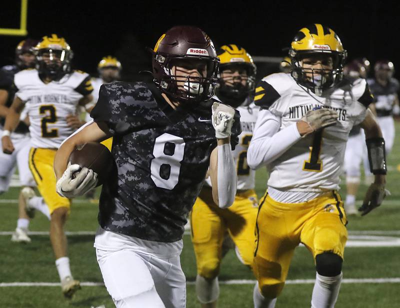 Richmond-Burton's Jack Martens runs for a touchdown as Harvard's Daniel Rosas gives chase during a Kishwaukee River Conference football game on Thursday, Oct.12, 2023, at Richmond-Burton High School.