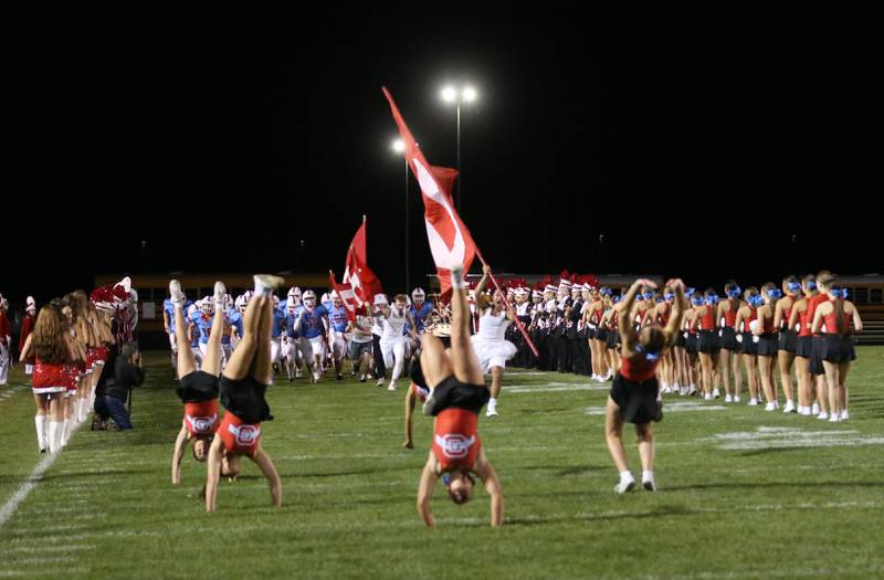 Ottawa cheerleaders perform flips as the football team runs onto the field during Homecoming on Friday, Oct. 4, 2024 at King Field.