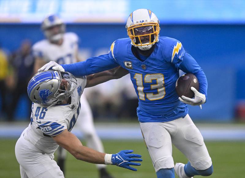 FILE - Los Angeles Chargers wide receiver Keenan Allen (13) rushes past Detroit Lions linebacker Jack Campbell (46) during an NFL football game Sunday, November 12, 2023, in Inglewood, Calif. The Chicago Bears are acquiring wide receiver Keenan Allen from the Los Angeles Chargers for a fourth-round pick, people informed of the decision told The Associated Press on Thursday, March 14, 2024. (AP Photo/Denis Poroy, File)