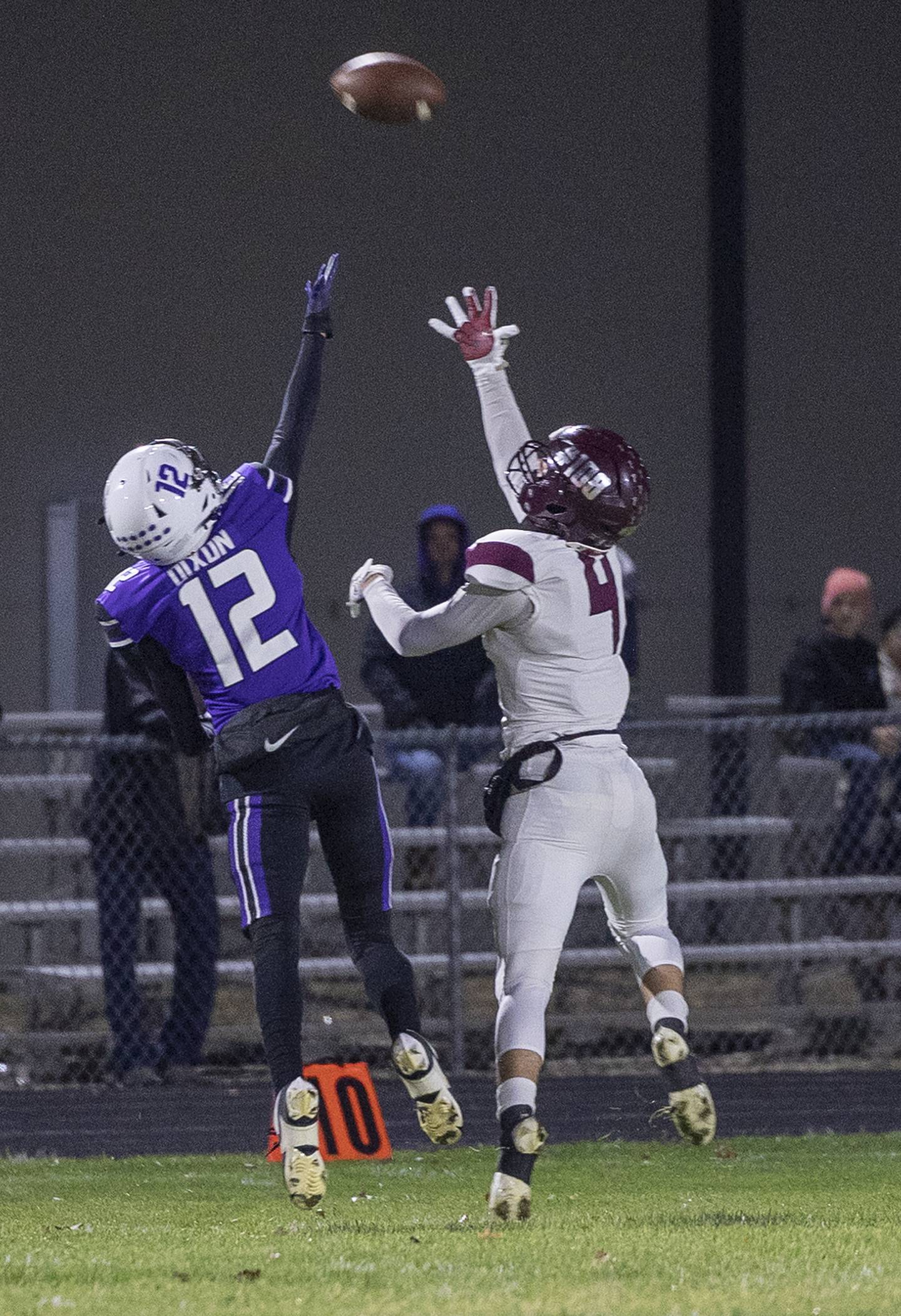 Marengo’s Parker Mandelky hauls in a pass against Dixon’s Gabe Rowley for a TD Friday, Nov. 1, 2024 in the 4A football playoffs in Dixon.