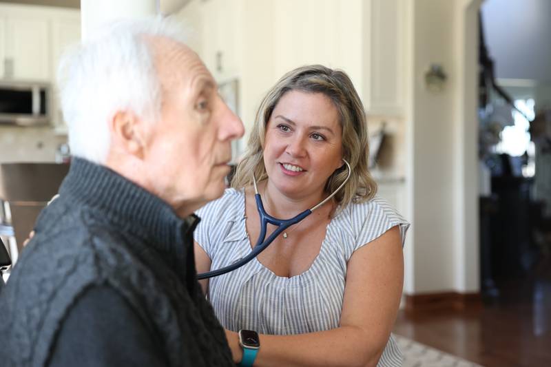 Nicole Hartley, lead nurse practitioner for Lightways’ serious illness care program, checks the vitals of Bob Jolly at his home on Wednesday March 6, 2024, in Lemont.