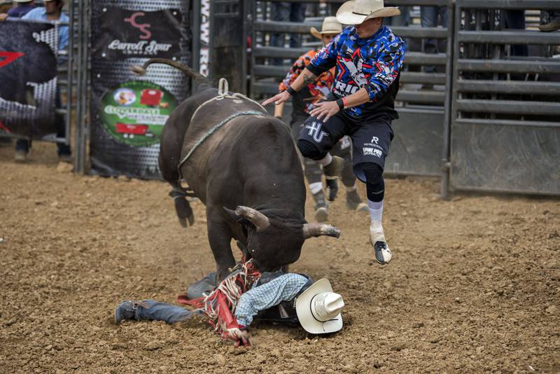 Desmond Hill of Tulsa, Oklahoma lays in the dirt as Crooked Clinton shoves him around after throwing him off during his ride Thursday in Milledgeville.