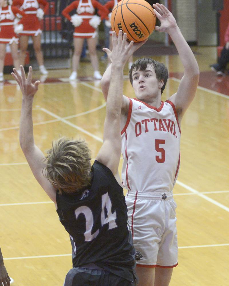 Ottawa’s Kyler Araujo shoots over the block attempt of Kaneland’s Luke Reinert in the 1st period Friday at Ottawa.