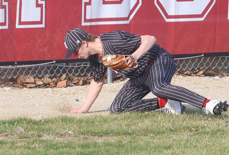 Hall's Hunter Edgcomb stumbles on the warning track after fielding a ball on Thursday, March 19, 2026 at Streator High School.