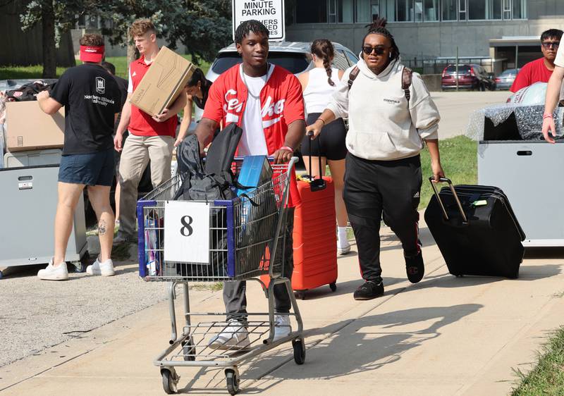 Northern Illinois University student volunteers help new arrivals get their things moved into their rooms Wednesday, Aug. 23, 2023, during move-in day in front of the Fanny Ruth Patterson Complex at NIU in DeKalb.