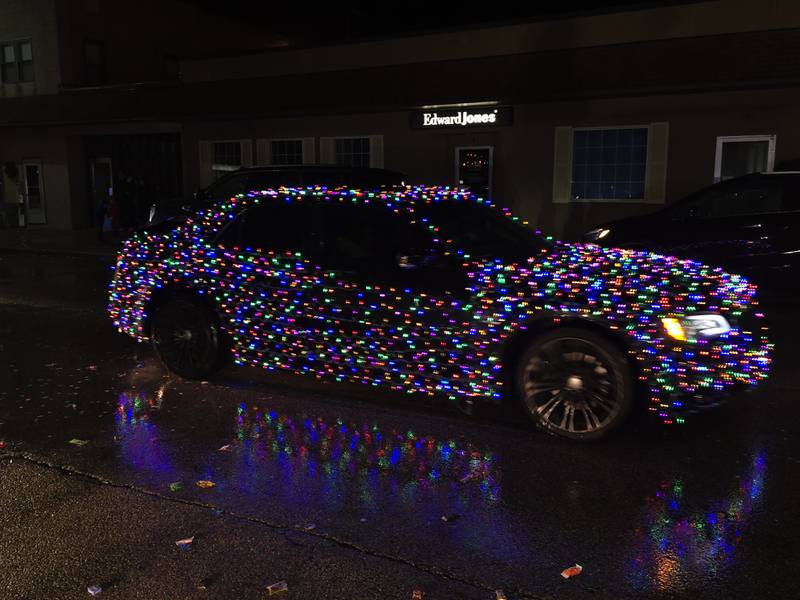 A lighted parade participant reflects itself in the wet roadway Saturday, Dec. 14, 2024, during the Winter Wonderland parade in Oglesby.