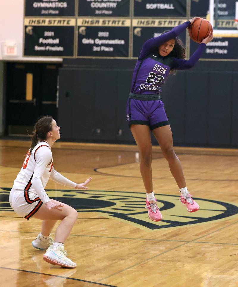 Dixon’s Ahmyrie McGowan grabs a high pass in front of Crystal Lake Central's Katie Hamill during their Class 3A sectional semifinal Tuesday, Feb. 20, 2024, at Sycamore High School.
