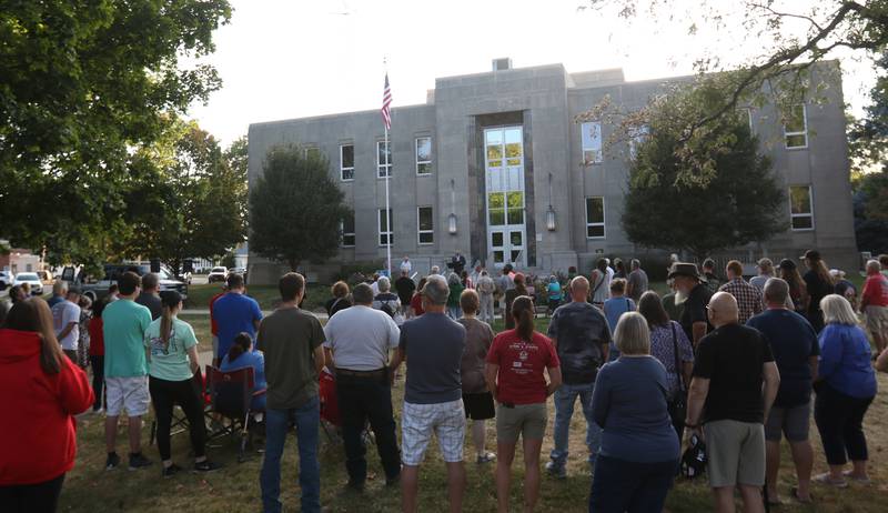 A large crowd of nearly 200 people gather during a vigil for Charlie Kirk on the front steps of the Bureau County Courthouse on Monday, Sept. 15, 2025 in Princeton.