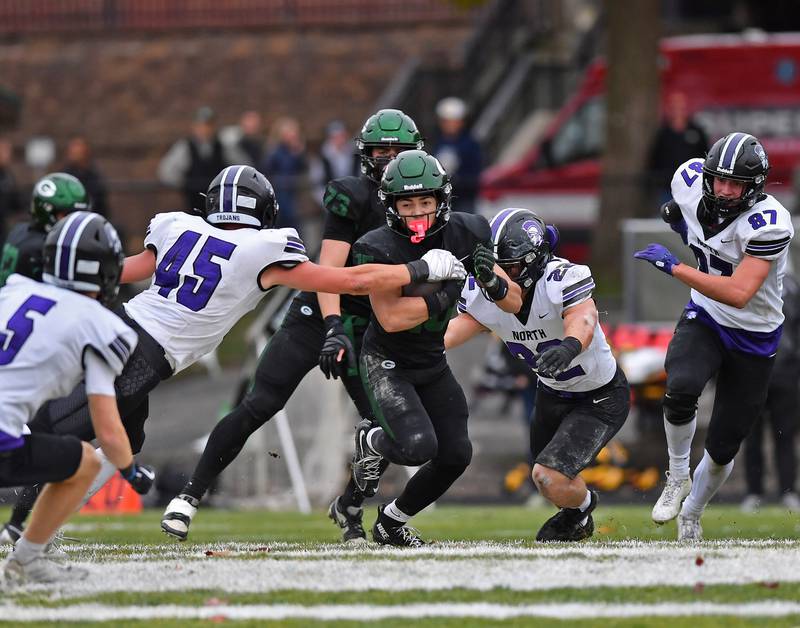 Glenbard West’s Mason Ellens (middle) draws a crowd of Downers Grove North defenders during a Class 7A second-round playoff game on November 8, 2025 at Glenbard West High School in Glen Ellyn.
