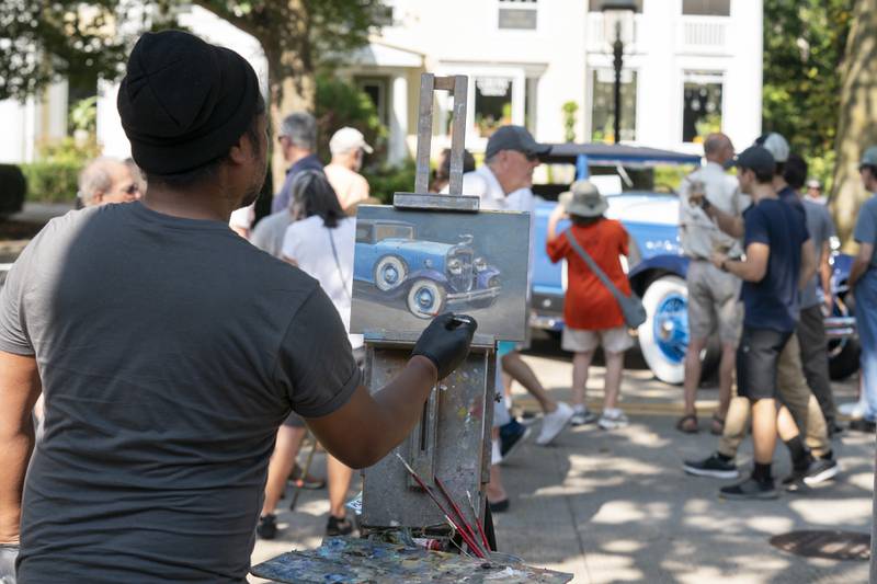 Artist John Paul Marcelo of Santa Rosa, Calif., paints a 1929 Cadillac Convertible Coupe during  the 2024 Geneva Concours d'Elegance on Sunday, August 25, 2024 in downtown Geneva. Car enthusiasts gathered along Third Street to display classic, antique and modern automobiles.