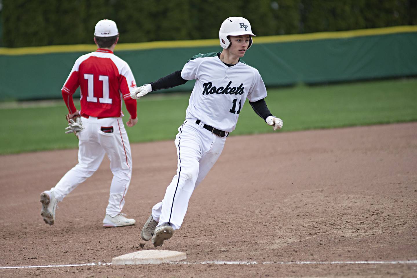 Rock Falls’ Gavin Sands rounds third and later scored on a wild throw Monday, April 25, 2022 against Oregon.