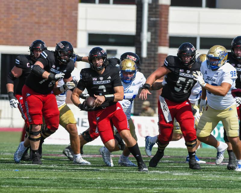 Northern Illinois University Ethan Hampton, center, finds an opening to gain extra yards during the first half of the game against Tulsa University on Saturday Sep. 23,2023 in DeKalb.